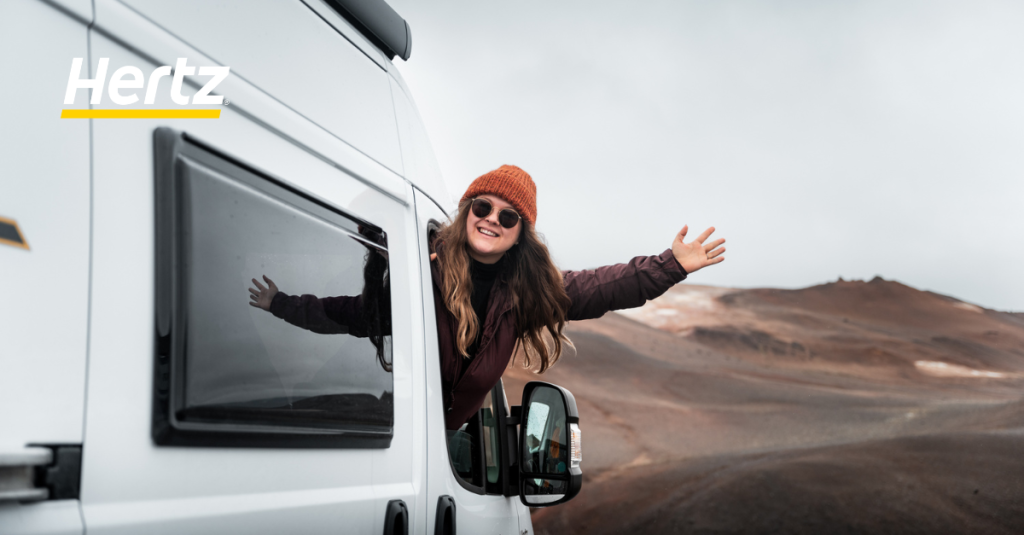 A happy toursits with a Hertz Camper RV