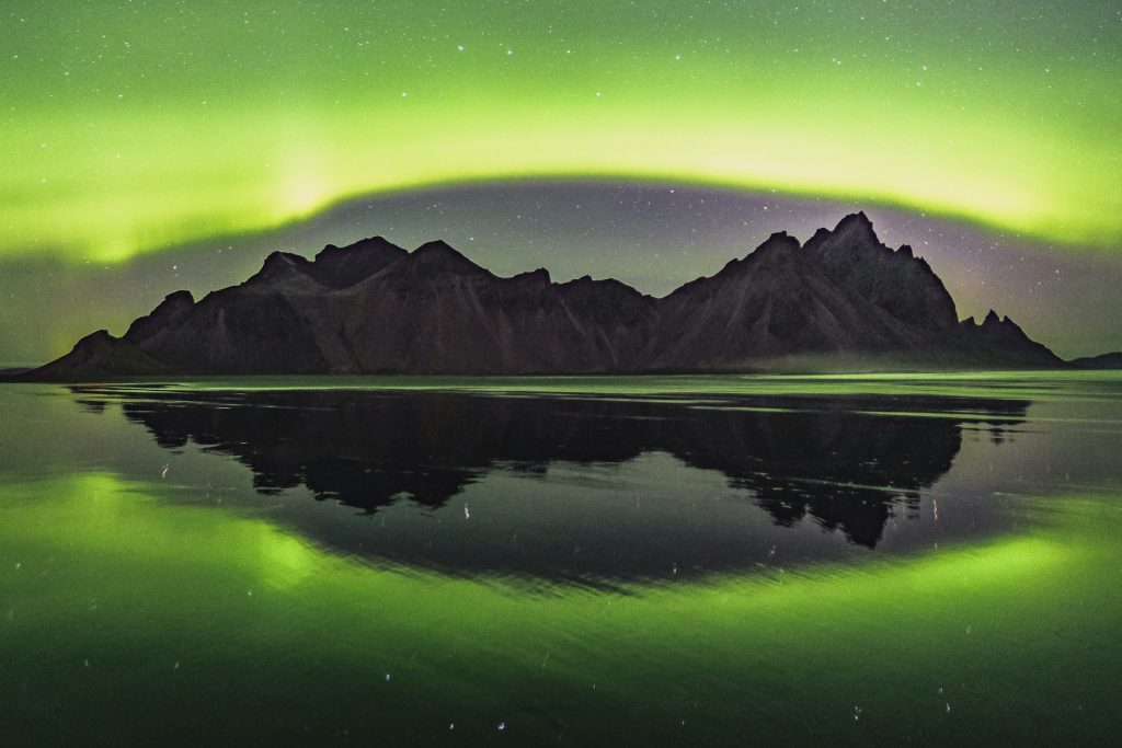 iceland vestrahorn mountain in winter with aurora